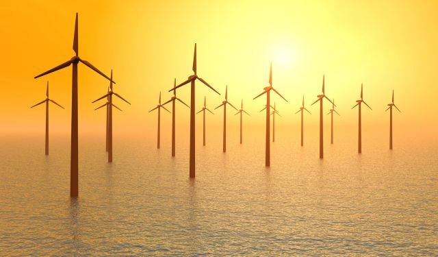 offshore wind farm with wind turbines in the dawn