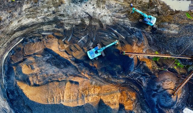 blue mining machines in the pit