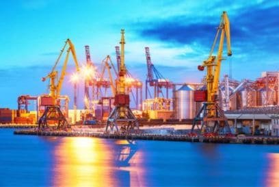 marine port with cranes and liquid fuel storage by night